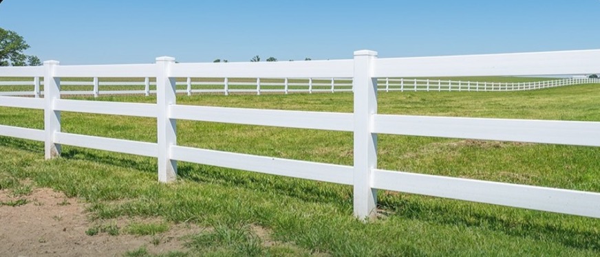White 3-rail ranch vinyl fence along open acreage